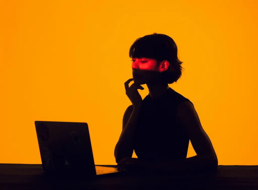 Orange background thinking lady